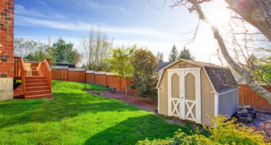 Fenced backyard with storage shed in Pensacola